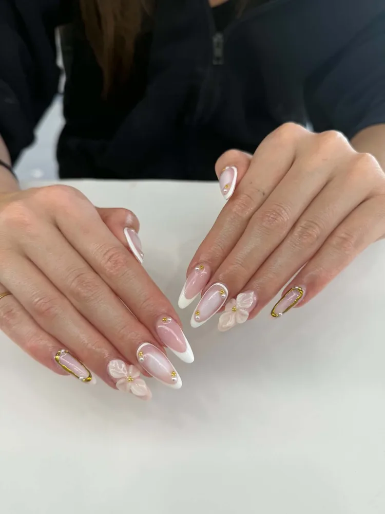 Almond nails in pink with white French tips, sculpted 3D flowers, gold beads and gold wire oval accents
